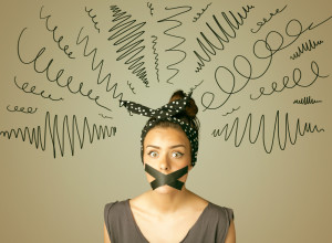 Young woman with taped mouth and curly lines around her head